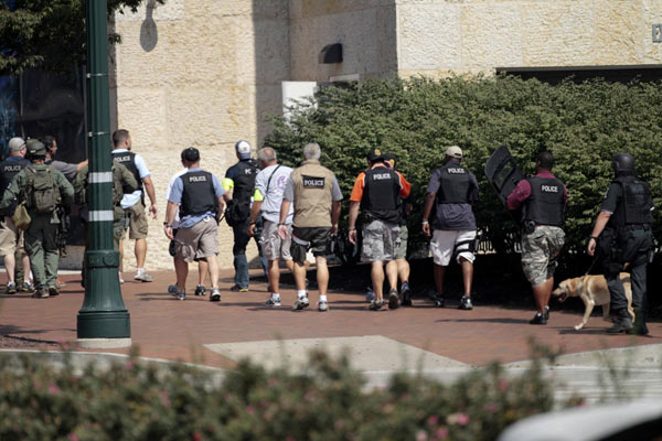 Police officers approach the Discovery Channel headquarters building in Silver Spring, Maryland, September 1, 2010. [China Daily/Agencies] 