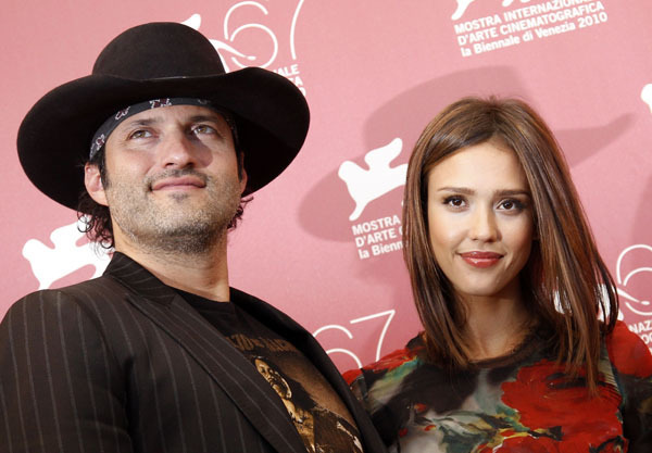 Director Robert Rodriguez (L) and actress Jessica Alba pose for photographers during a photocall for the movie 'Machete' at the 67th Venice Film Festival September 1, 2010.