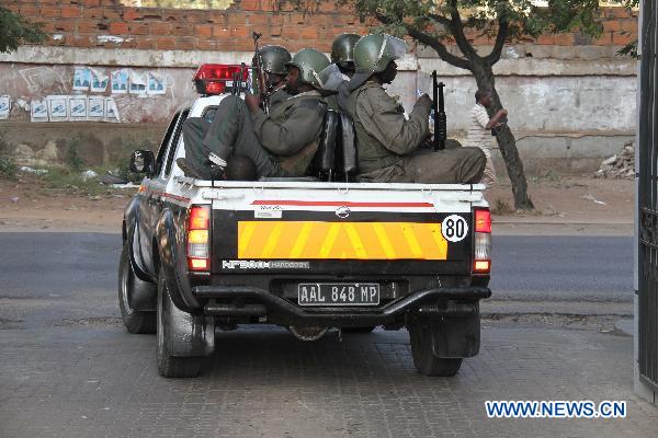 Police patrol a street in Maputo, capital of Mozambique, Sept. 2, 2010. [Liu Dalong/Xinhua]