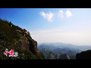 Mount Langshan is one of China's National Geological Park famous for its unique Danxia landform. It is located in Xinning county, Hunan province. In the south Mount Langshan is connected with Guilin, in the north it echoes Zhangjiajie. Three limestone caves and formative forest attracts many people to come. [Photo by Guan Peng]