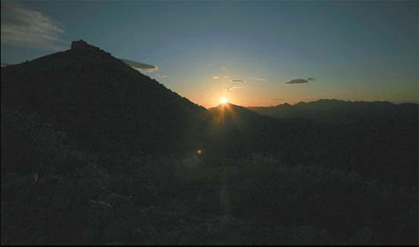 The silhouette of the Yangbian Great Wall is made out against the red rays of a setting sun. Liu Di / for China Daily