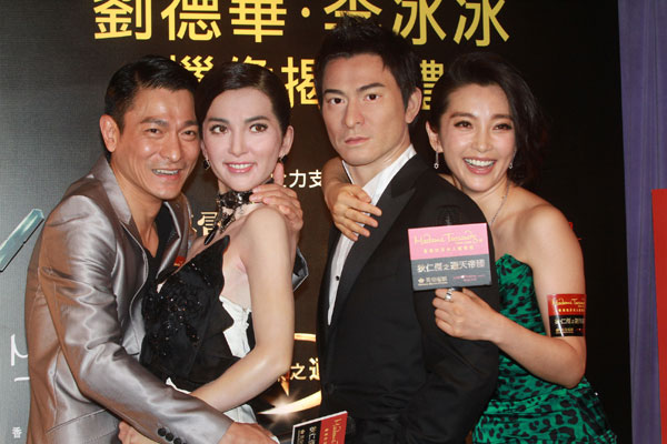 Actress Li Bingbing and actor Andy Lau pose with their wax figures at the Madame Tussaud's wax museum in Hong Kong on Wednesday, September 1, 2010.