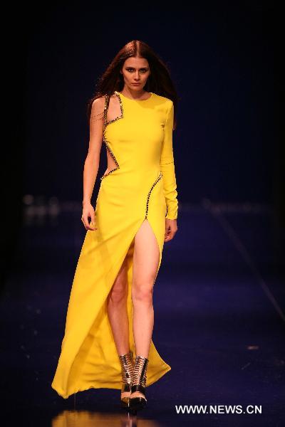 A model presents fashionable styles designed by Versace at the world masters fashion show 2010 held in Dalian, a coastal city in northeast China's Liaoning Province, on the night of Sept. 4, 2010.