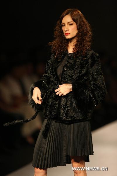 A model presents fashionable styles designed by Guy Laroche at the world masters fashion show 2010 held in Dalian, a coastal city in northeast China's Liaoning Province, on the night of Sept. 5, 2010.