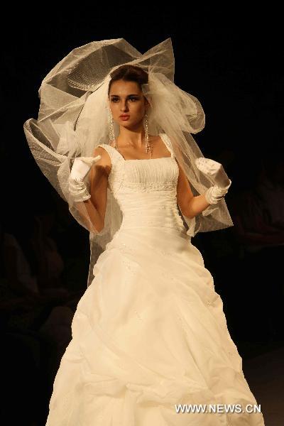 A model presents fashionable styles designed by Pronovias at the world masters fashion show 2010 held in Dalian, a coastal city in northeast China's Liaoning Province, on the night of Sept. 6, 2010.