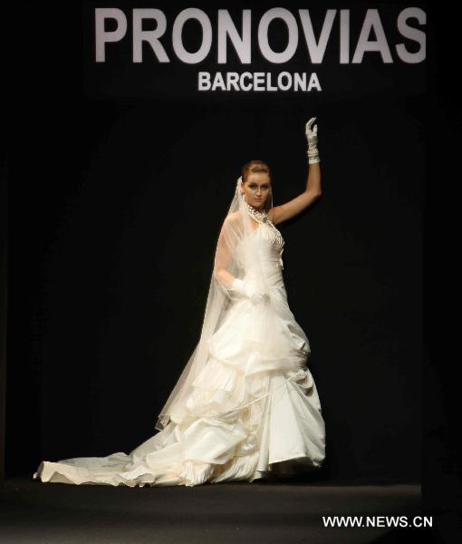 A model presents fashionable styles designed by Pronovias at the world masters fashion show 2010 held in Dalian, a coastal city in northeast China's Liaoning Province, on the night of Sept. 6, 2010.