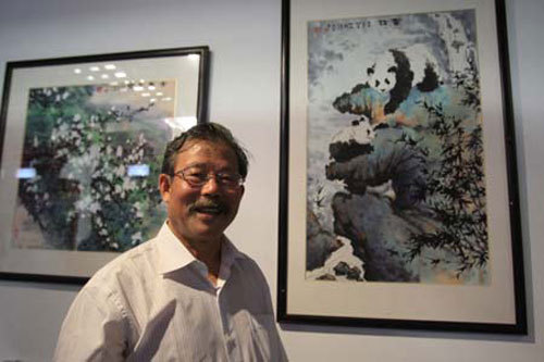 Zhang Yongsheng, a painter from the Zhejiang Fine Arts Academy, shows his works at the DEVNET Pavilion.  