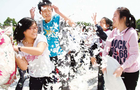 Students in their last year at Lintou High School in Hanshan county, Anhui province, take part in a pillow fight as part of a stress-busting exercise. 