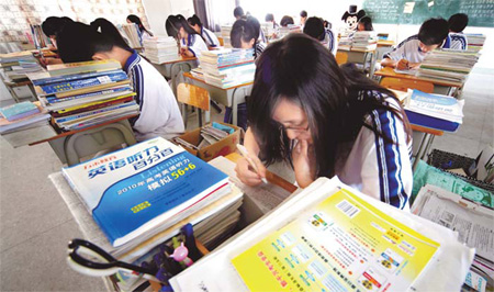 Pupils surrounded by textbooks prepare at Yinghua Foreign Languages School in Shantou, Guangdong province.