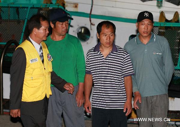 Chinese crew members of South Korean fishing boat &apos;Daeseung 55&apos; Sun Peng (2nd L), Chen Wenxing (2nd R) and Ge Fengqi (1st R) are seen in Sokcho, South Korea, on Sept. 7, 2010. South Korean fishing boat &apos;Daeseung 55&apos;, released on Tuesday by the Democratic People&apos;s Republic of Korea (DPRK), arrived in South Korea&apos;s port city of Sokcho in the evening. [Xinhua]