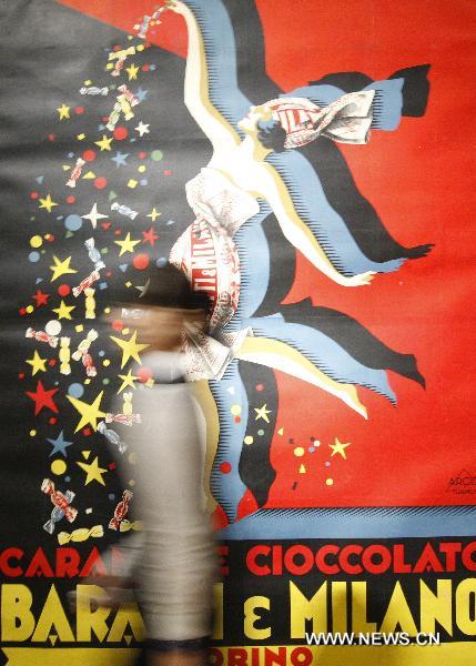 A visitor passes an artwork created by Italian futurist Pluto during the Italian Futurism Exhibition held in China's National Art Museum in Beijing, capital of China, Sept. 7, 2010. The exhibition, kicking off on Tuesday, displayed 262 pieces of paintings, sculptures and posts featuring the Italian Futurism which flourished since the beginning of 20th century.