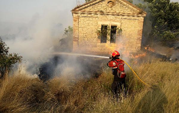 A firefighter tries to extinguish a forest fire near Valencia, September 7, 2010. 