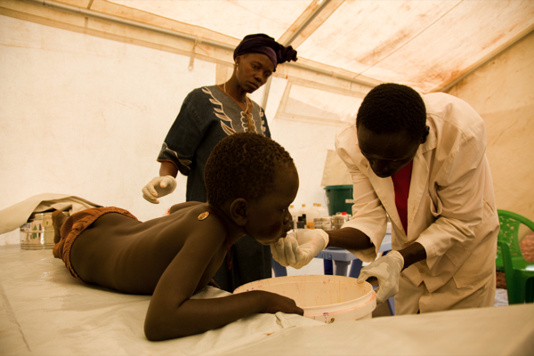 Médecins Sans Frontières (MSF) nurses attend to a young boy who&apos;s lip was cut in a school yard fight in Nyori Refugee camp, South Sudan.More than five years after the signing of the Comprehensive Peace Agreement, medical needs in south Sudan remain critical. Médecins Sans Frontières (MSF) provides care to hundreds of thousands of people with all levels of healthcare, ranging from consultations for respiratory tract infections to life-saving surgery in South Sudan.[Brendan BANNON]