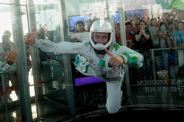 A Latvian acrobat performs in a wind tunnel which blows off winds of 200 kilometers per hour from the bottom, in the Latvia Pavilion in the Shanghai World Expo Park in Shanghai, east China, Sept. 8, 2010. 