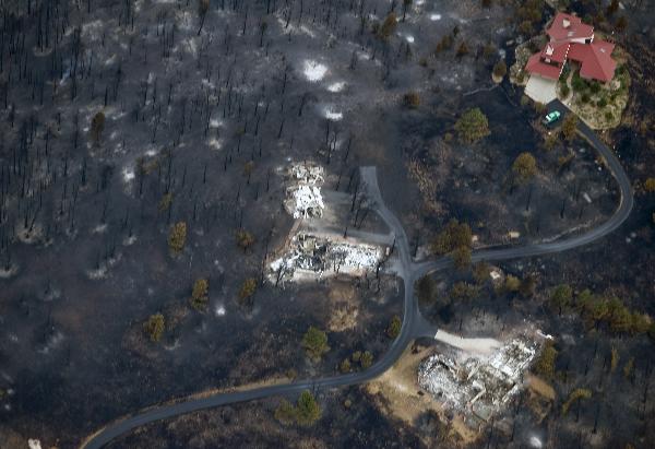 An aerial view shows a seemingly untouched home next to two other homes that were destroyed by the Fourmile Canyon fire in Boulder, Colorado September 8, 2010.