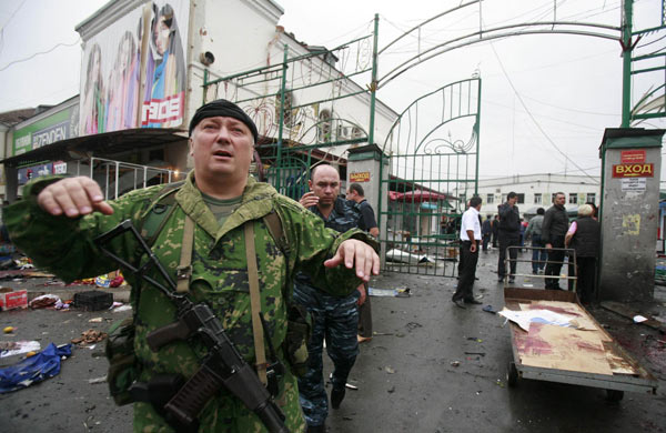 A serviceman gestures at a blast site in Vladikavkaz September 9, 2010. [China Daily/Agencies]