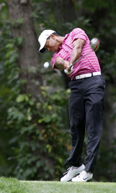 Woods hits a tee shot on seventh hole during the first round of the BMW Championship golf tournament in Lemont Tiger Woods of the U.S. hits a tee shot on the seventh hole during the first round of the BMW Championship golf tournament in Lemont, Illinois September 9, 2010. (Xinhua/Reuters)