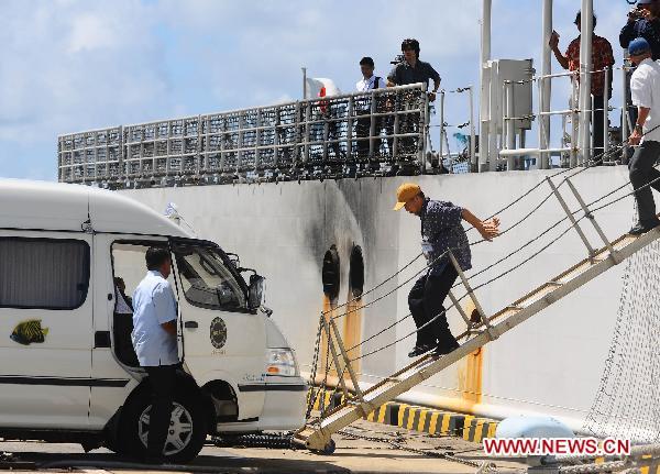 Chinese boat crew members get off the ship at the Ishigaki harbor to go to Ishigaki airport in Okinawa, Japan, Sept. 13, 2010. The 14 Chinese fishermen on board the trawler which had been kept by Japanese authorities at Ishigaki harbor in Okinawa since Tuesday's collision are on their way back to China.