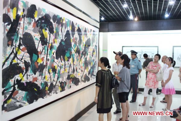 Visitors view paintings at the exhibition in honour of late Chinese artist Wu Guanzhong held in his hometown Yixing City, east China's Jiangsu Province, Sept. 12, 2010. The exhibition displayed 30 pieces of works of Wu, a master of Chinese paintings.