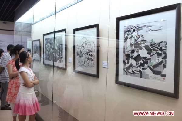 Visitors view paintings at the exhibition in honour of late Chinese artist Wu Guanzhong held in his hometown Yixing City, east China's Jiangsu Province, Sept. 12, 2010. The exhibition displayed 30 pieces of works of Wu, a master of Chinese paintings.