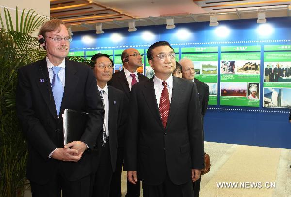 Chinese Vice Premier Li Keqiang (R, front) and World Bank President Robert Zoellick (L, front) visit an exhibition before the opening ceremony of the Conference ot the 30th Anniversary of China-World Bank Cooperation in Beijing, Sept. 13, 2010. [Liu Weibing/Xinhua]