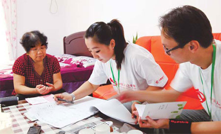 Two census-takers fill in a questionnaire at the home of a resident in Beijing. 