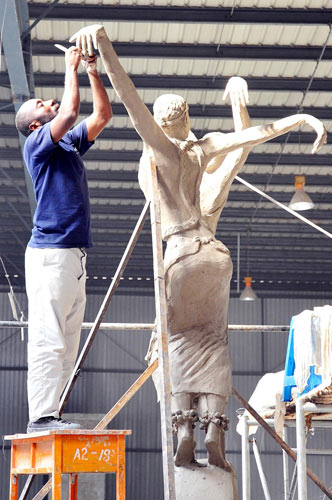 A Rwandan artist works on his piece for the international sculpture exposition in Changchun, Northeast China&apos;s Jilin province, Sept 13, 2010. [Xinhua]