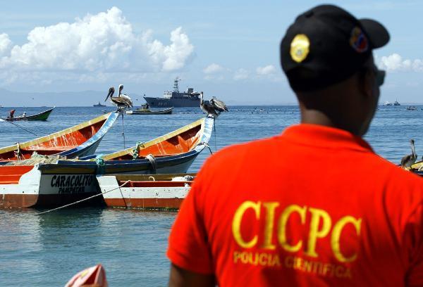 A rescuer looks on to the sea at a military base at Margarita Island of Venezuela, Sept. 14, 2010. A Venezuelan military helicopter crashed into a navy research vessel here Tuesday and plunged into the sea, killing two people and injuring five, an official said. [Xinhua] 