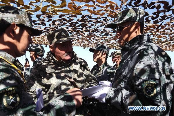 Officers discuss during the joint military training of troops from five Shanghai Cooperation Organization member states in Matybulak Range in Kazakhstan, Sept. 14, 2010. As part of the &apos;Peace Mission 2010&apos; joint anti-terror drills, soldiers and military officers from Kazakhstan, China, Kyrgyzstan, Russia and Tajikistan conducted the joint military training in Kazakhstan on Tuesday.[Xinhua] 