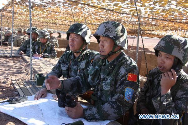 Chinese officers attend the joint military training of troops from five Shanghai Cooperation Organization member states in Matybulak Range in Kazakhstan, Sept. 14, 2010. As part of the &apos;Peace Mission 2010&apos; joint anti-terror drills, soldiers and military officers from Kazakhstan, China, Kyrgyzstan, Russia and Tajikistan conducted the joint military training in Kazakhstan on Tuesday.[Xinhua]