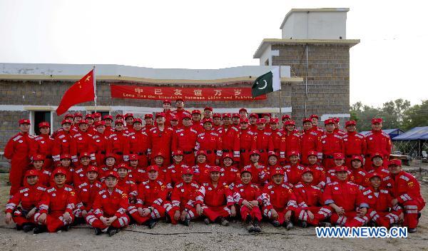 China's second group of aid workers pose for a group photo upon their arrival at Thatta, Pakistan, Sept. 14, 2010. The second Chinese aid team, consisting of 59 members, arrived in Thatta region, which was the worst-hit area in Pakistan's recent nationwide flood, on Tuesday to continue the humanitarian mission. [Zhou Lei/Xinhua]