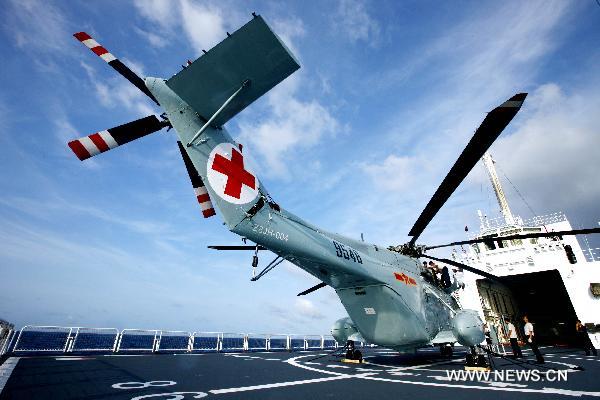 A new model of rescue medical helicopter is seen aboard hospital ship Peace Ark of the Navy of the Chinese People's Liberation Army (PLA) prior to its takeoff during an exercise in the sea area of Indian Ocean, Sept. 14, 2010. The helicopter made its first debut on Monday after successfully accomplishing the landfall task on the board of Peace Ark. [Xinhua photo] 