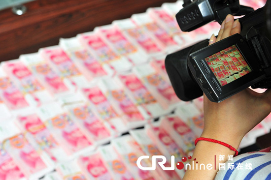 Seized counterfeit renminbi are seen in Xian, Shaanxi province, Sept 14, 2010. 