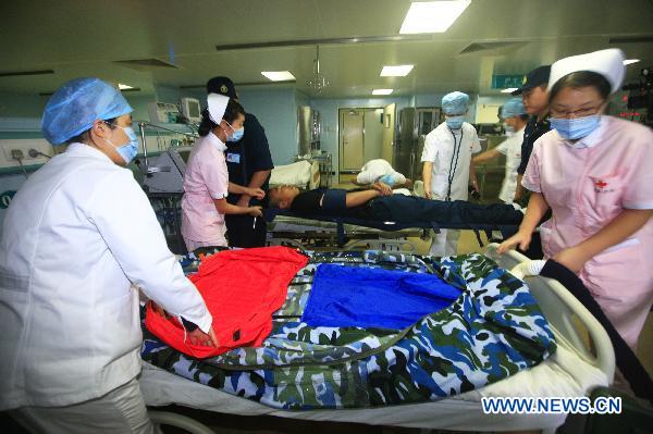 Medical workers treat mock wounded people during an exercise aboard the Chinese navy hospital ship Peace Ark Sept. 15, 2010. The ship on Wednesday arrived in the Gulf of Aden to provide medical service for the Chinese escort fleet, as its first overseas medical mission. [Xinhua] 