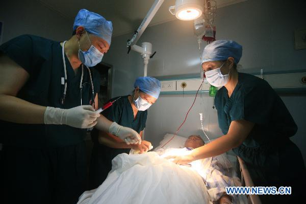 Medical workers treat mock wounded people during an exercise aboard the Chinese navy hospital ship Peace Ark Sept. 15, 2010. The ship on Wednesday arrived in the Gulf of Aden to provide medical service for the Chinese escort fleet, as its first overseas medical mission. [Xinhua]