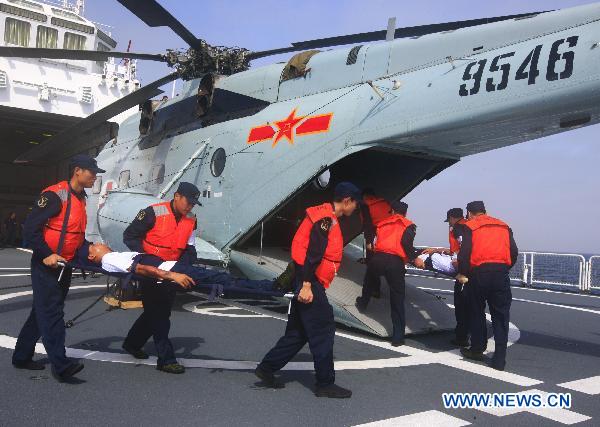 Medical workers transfer mock wounded people into a rescue medical helicopter during an exercise aboard the Chinese navy hospital ship Peace Ark Sept. 15, 2010. The ship on Wednesday arrived in the Gulf of Aden to provide medical service for the Chinese escort fleet, as its first overseas medical mission. [Xinhua] 