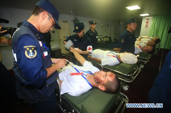 Medical workers treat mock wounded people during an exercise aboard the Chinese navy hospital ship Peace Ark Sept. 15, 2010. The ship on Wednesday arrived in the Gulf of Aden to provide medical service for the Chinese escort fleet, as its first overseas medical mission. [Xinhua]