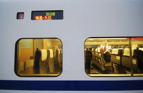 A steward is seen inside a high-speed train for Jiujiang from Nanchang.[Xinhua]