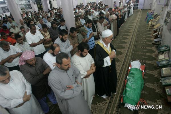 Palestinians pray in front of the body of Wajdi Al-Kadi, who was killed in an Israeli air strike on smuggling tunnels, during his funeral at a mosque in Rafah, southern Gaza Strip, on Sept. 15, 2010. Al-Kadi was killed and two others were wounded Wednesday afternoon as Israeli warplanes attacked smuggling tunnels along Gaza&apos;s southern border with Egypt, witnesses and security sources said. [Xinhua]