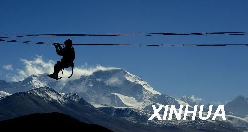 An electrical worker is maintaining wires for the Tibetan power network with an elevation of about 5000 meters in this file photo taken on October 19, 2009. China will spend 16 billion yuan (2.37 billion U.S. dollars) in connecting the grids of Qinghai and Tibet during the next years. 