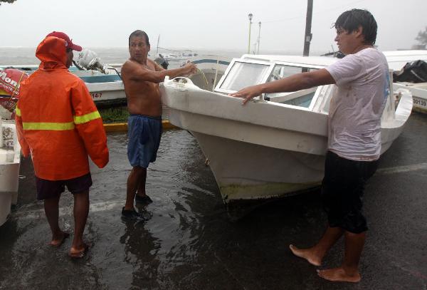 Fishermen take their boat out of the waters during strong winds and heavy rains brought by Hurricane Karl at Veracruz port in Mexico Sept. 17, 2010. Hurricane Karl bore down on Mexico's central Gulf Coast on Friday. [Barbara Dector/Xinhua]