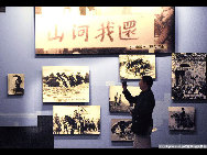 A visitor views file photos at the 9.18 Historical Museum in Shenyang, capital of northeast China's Liaoning Province, Sept. 17, 2010. [Yang Xinyue/Xinhua] 