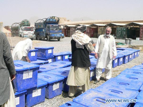 Staff members stand beside boxes of ballots in Kandahar of Afghanistan, Sept. 16, 2010. Southern Afghan Kandahar province on Thursday began to distribute ballots to poll stations prior to the upcoming parliamentary elections set for September 18. [Zalmay/Xinhua] 