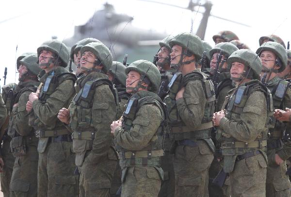 Russian soldiers wait for orders during an exercise of 'Peace Mission 2010' joint anti-terror drills conducted by five Shanghai Cooperation Organization (SCO) member states in Matybulak Range of Kazakhstan, Sept. 18, 2010. Troops from five SCO countries launched the first live firing drill Friday in the southern Kazakh training ground. [Wang Jianmin/Xinhua]