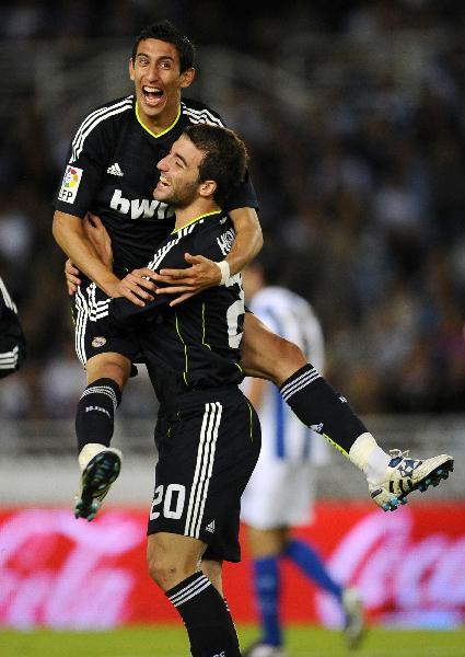 Real Madrid's Angel Di Maria (top) celebrates his goal against Real Sociedad wiht his team-mate Gonzalo Higuain during their Spanish First Division soccer match at the Anoeta stadium in San Sebastian September 18, 2010. (Xinhua/Reuters Photo)