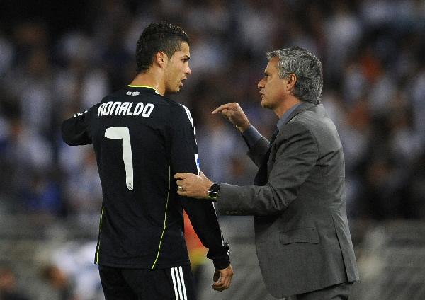 Real Madrid's coach Jose Mourinho gives instructions to Cristiano Ronaldo during their Spanish First Division soccer match against Real Sociedad at the Anoeta stadium in San Sebastian September 18, 2010. (Xinhua/Reuters Photo)