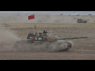 Chinese tanks run for targets during an exercise of 'Peace Mission 2010' joint anti-terror drills conducted by five Shanghai Cooperation Organization (SCO) member states in Matybulak Range of Kazakhstan, Sept. 18, 2010. Troops from five SCO countries launched the first live firing drill Friday in the southern Kazakh training ground. [Sohu]