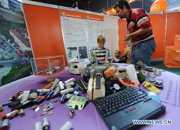 Visitors look at electronic and heavy metal products wastes process circuit at garbage festival held by MA48, or Vienna urban waste disposal center, in Vienna, capital of Austria, Sept. 19, 2010.