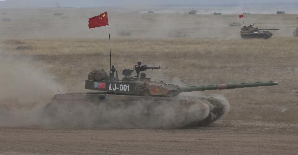 Chinese tanks run for targets during an exercise of 'Peace Mission 2010' joint anti-terror drills conducted by five Shanghai Cooperation Organization (SCO) member states in Matybulak Range of Kazakhstan, Sept. 18, 2010. Troops from five SCO countries launched the first live firing drill Friday in the southern Kazakh training ground. [Wang Jianmin/Xinhua]