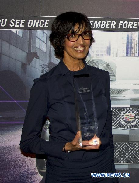Judy Koonar, on behalf of his husband Sturla Gunnarsson, receives the People's Choice Documentary Award during the 35th Toronto International Film Festival in Toronto, Canada, Sept. 19, 2010. 'Force of Nature:The David Suzuki Movie' directed by Sturla Gunnarsson was awarded the People's Choice Documentary Award.